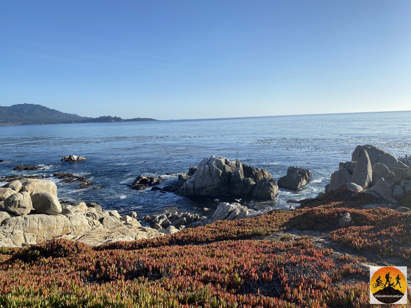 Red iceplant covering the shoreline at Point Joe, with granite sea stacks and turquoise water beyond
