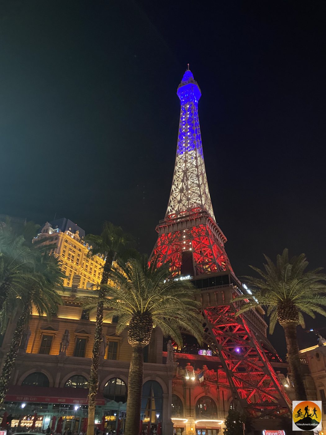 The half scale Eiffel Tower at Paris Las Vegas lit red white and blue against the night sky